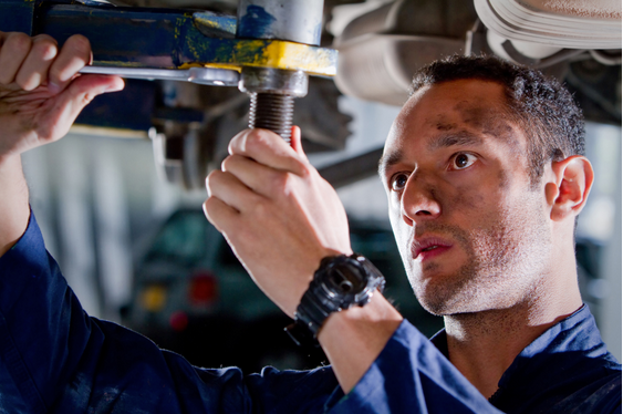 mechanic performs car maintenance at evans tires