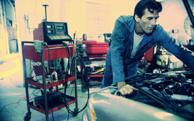 Car maintenance technician checking under hood image